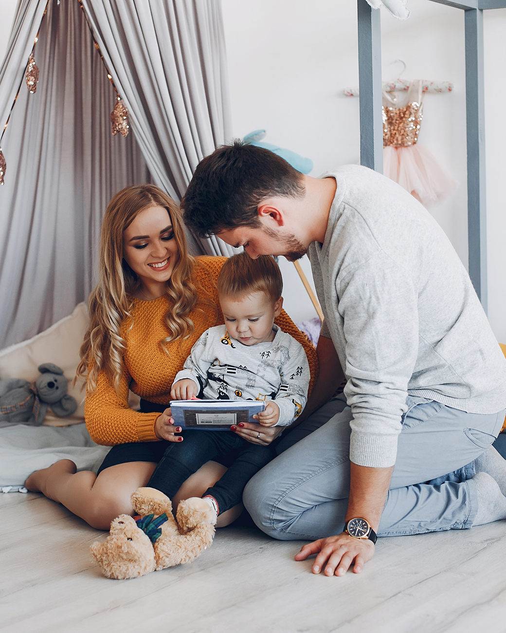 A family sitting on the floor at home